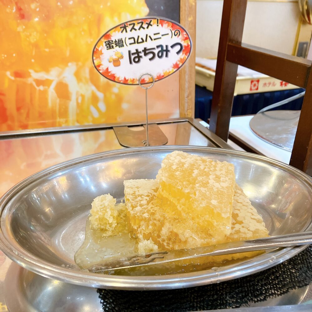 「オススメ！蜜蝋（コムハニー）のはちみつ」というPOPと共に置かれた、黄金色に輝く巣蜜。